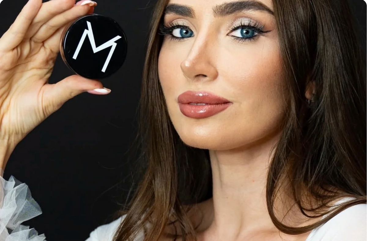 Model wearing VooDoo Makeup and holding a VooDoo Makeup compact, showcasing clean beauty and bold cosmetics in Katy, Texas.