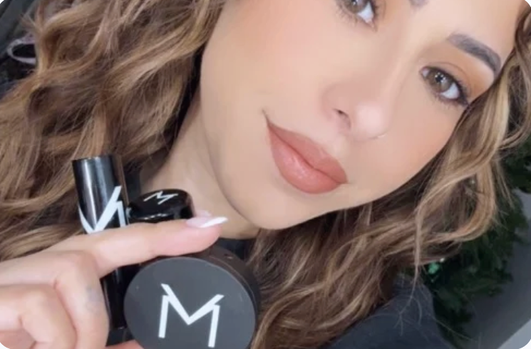Beauty model holding VooDoo Makeup cosmetics, featuring clean, high-performance makeup inspired by New Orleans and based in Katy, Texas.