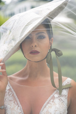 Woman in a lace dress holding a hat with a transparent veil — Voodoo Makeup (Katy/Houston, TX)